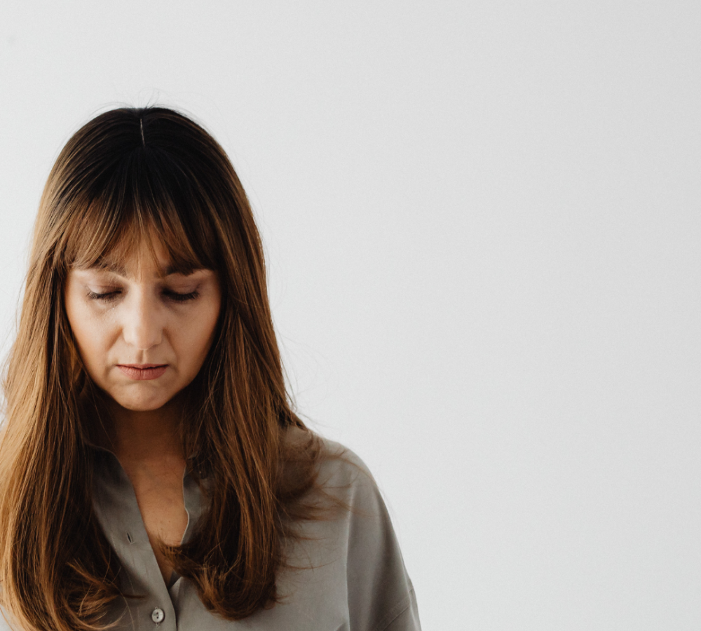 women looking down experiencing emotional effects of abortion