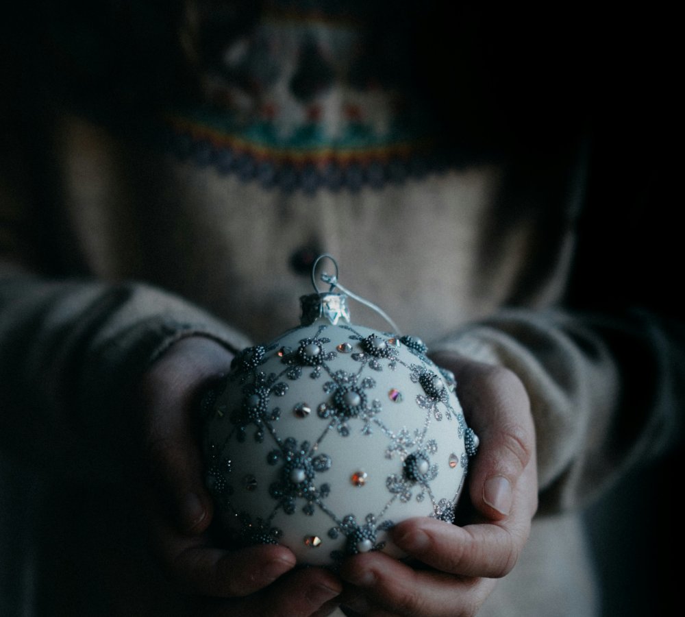 Moody scene - Woman holding a Christmas ornament